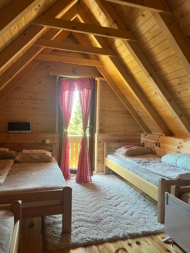 a bedroom with two beds in a attic at Komovi-Apartment in Kolašin