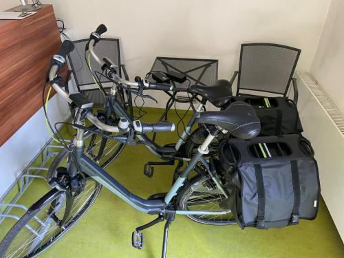 a bike parked in a room with two chairs at Penzion Andy in Děčín