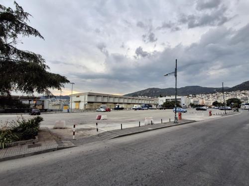 an empty street with a parking lot and a building at The Arch Nest in Kavala
