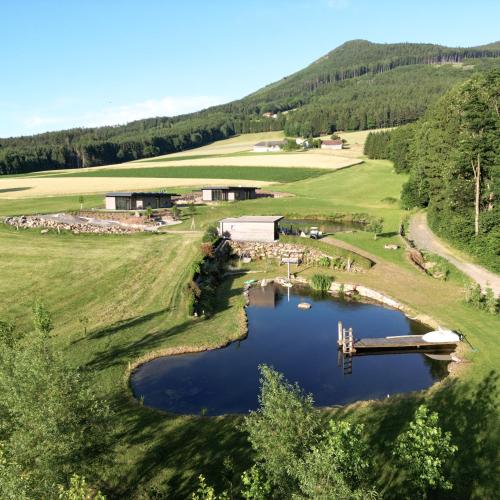 an aerial view of a golf course with a pond at Lodge am Wasser in Yspertal