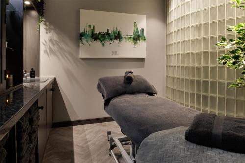 a spa room with a bed and a counter at Hilton Cardiff in Cardiff