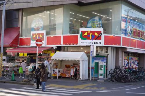 a store with a tent in front of a street at nagumobiru202 in Tokyo