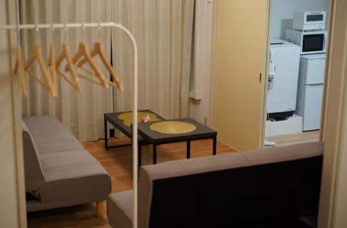 a small living room with a table and a couch at nagumobiru202 in Tokyo