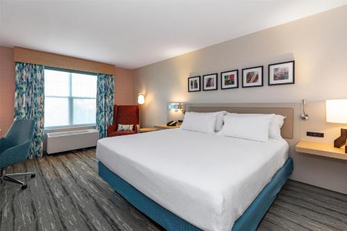 a hotel room with a large bed and a window at Hilton Garden Inn Auburn in Auburn