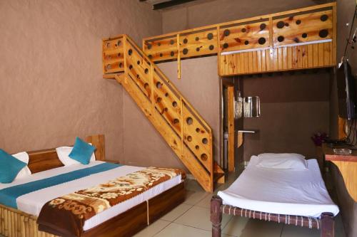 two beds in a room with a bunk bed at Mera Gaon Mera Desh Resort in Sonīpat