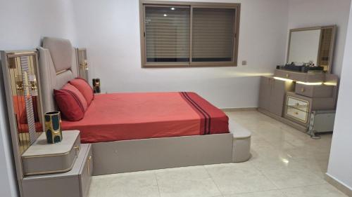 a bedroom with a bed and a dresser and a mirror at Luxe Suite au sein d'une villa in Rabat