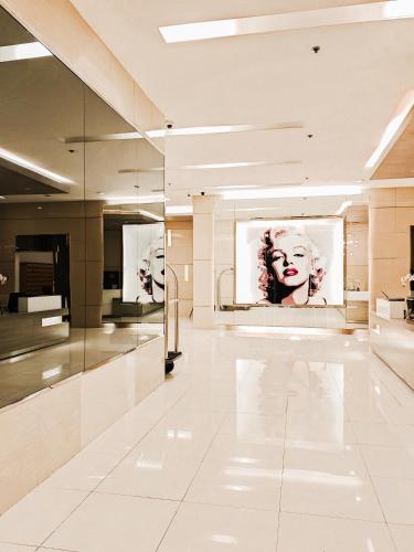 a large white room with two pictures on the wall at Spacious studio MPLACE Tower C in Manila