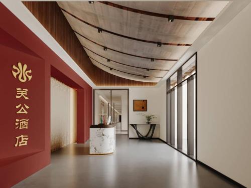 a large room with a wooden ceiling and a table at Guan Gong Hotel Jin Shang Development Jonker Street in Melaka