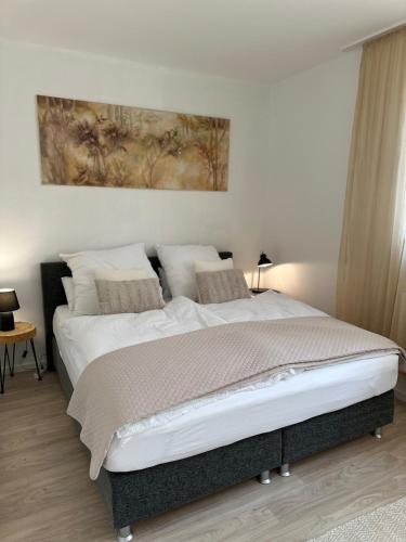 a bedroom with a large bed with white sheets and pillows at Apartment with a great location in Weilheim in Weilheim in Oberbayern