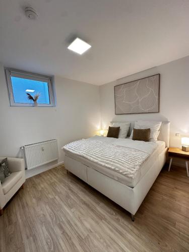a bedroom with a large white bed and a window at Apartment with a great location in Weilheim in Weilheim in Oberbayern