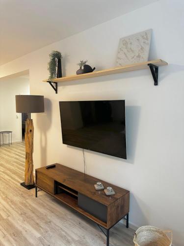 a living room with a flat screen tv on a wall at Apartment with a great location in Weilheim in Weilheim in Oberbayern
