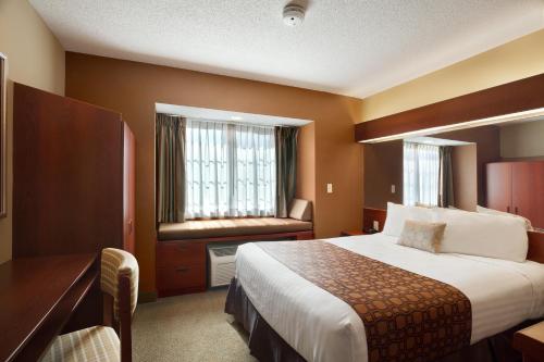 A bed or beds in a room at Microtel Inn & Suites Dover by Wyndham