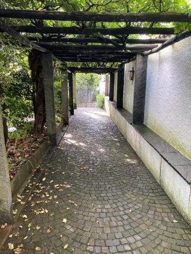 an empty walkway with awning over a brick road at Ferienwohnung Brissago in Brissago