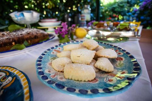 a table with a plate of biscuits on a table at Casa Rosaria Amalfi Coast in Vietri sul Mare