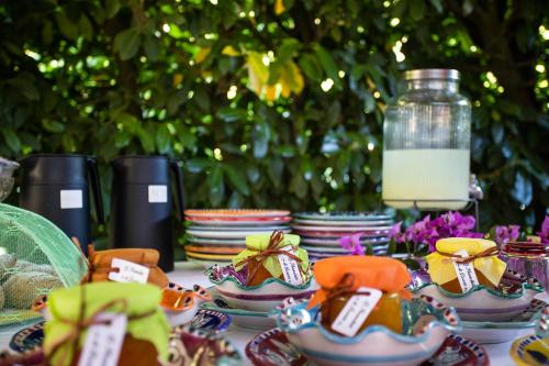 a table with plates of food and a jar of milk at Casa Rosaria Amalfi Coast in Vietri sul Mare