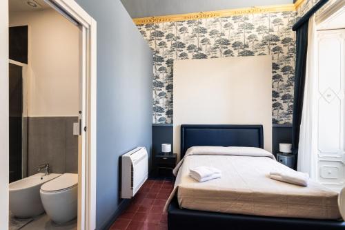 a bedroom with a bed and a tub and a sink at Palazzo Giangreco Luxury Rooms in Avola