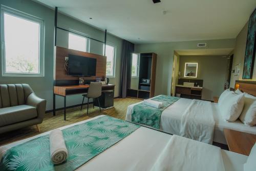 a hotel room with two beds and a desk at NB HOTEL in Johor Bahru