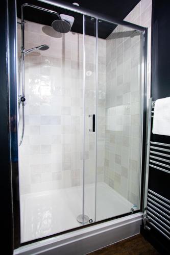 a shower with a glass door in a bathroom at Settle Southampton - Stylish Self Check-In Rooms & Self Catering Suites in Southampton