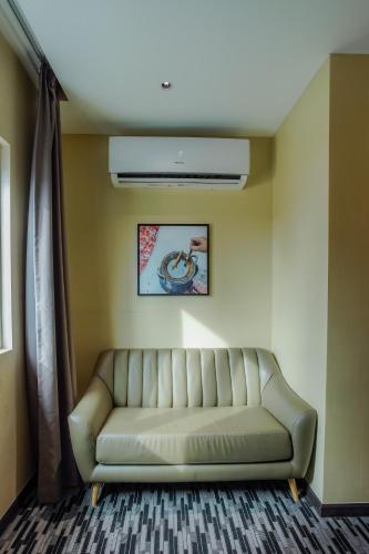a living room with a couch in a room at NB HOTEL in Johor Bahru