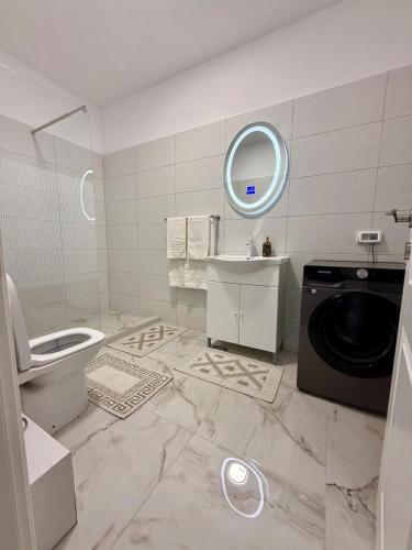a bathroom with a washing machine and a washer at Apartament Lucas in Agigea