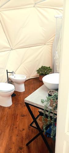 a bathroom with two sinks and two toilets in a tent at Lunaria Manziana in Sambuco