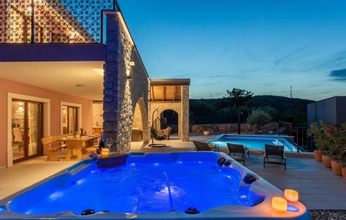 a large blue tub in a backyard with a pool at Holiday home Villa Vrbnik by Villas guide in Vrbnik