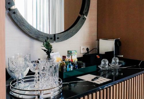 a counter with glasses on it with a mirror at Hospes Palacio de los Patos, a Member of Design Hotels in Granada