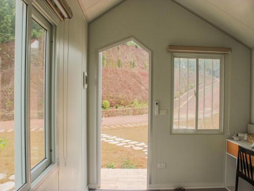 an open door in a room with a window at Halo Retreat in Hòa Bình