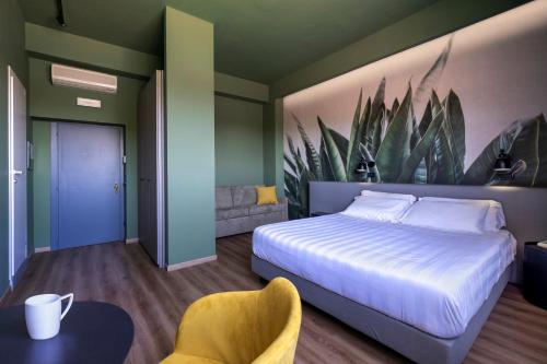 a bedroom with a bed and a painting of plants at Hotel Del Lago Piediluco Active & SPA in Piediluco