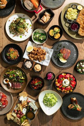 a table with many plates of food on it at Budapest Marriott Hotel in Budapest