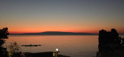 a sunset over a large body of water at Casa Vacanze Donna Lia in Giardini Naxos
