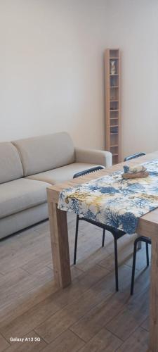 a living room with a couch and a table at Casa Vacanze Donna Lia in Giardini Naxos