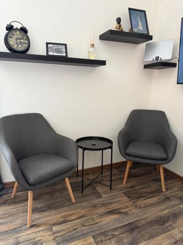 two chairs and a table in a room at Apartmán Pardubice in Pardubice