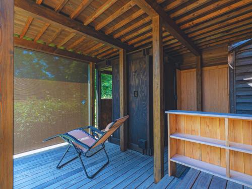 a porch of a cabin with a chair on it at NIPPONIA Sado 佐渡相川 金山町 in Sado