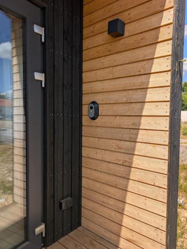 a wooden front door of a house at Tiny House Chambre Salon Cuisine by EXTINY in Richardménil