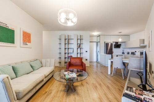 a living room with a couch and a table at Hill Side Suite 4 by PS in Durrës