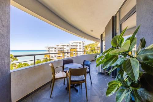 a balcony with a table and chairs and the ocean at Hill Side Suite 4 by PS in Durrës