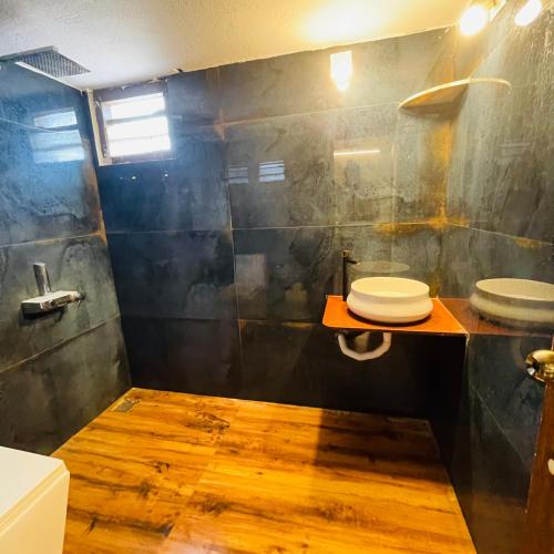 a bathroom with a sink and a toilet in it at Vistara Beach Resort Malpe - Udupi in Udiyāvara