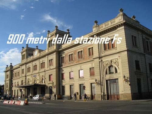 a large building with a sign on the side of it at Hotel Marta in Forlì