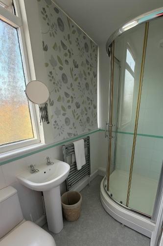 a bathroom with a sink and a shower at 4 Seaview Sheringham in Sheringham