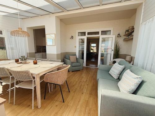 a living room with a table and a couch at 4 Seaview Sheringham in Sheringham