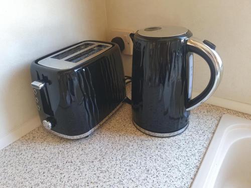 a toaster and a toaster sitting on a counter at 3 Bed Caravan sleeps 8 in Skegness