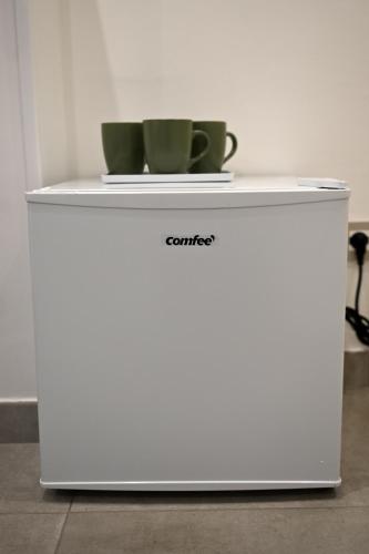a white refrigerator with a cup on top of it at Domus Cassino Centro in Cassino