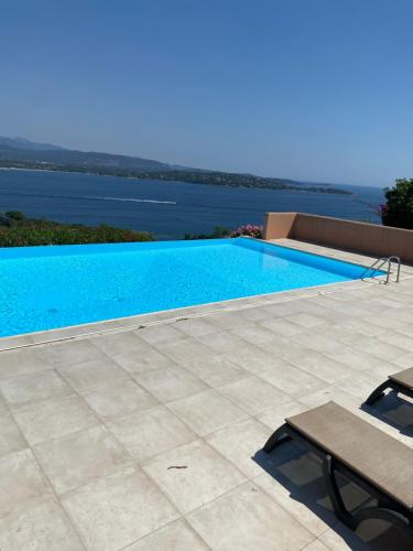 a swimming pool with a view of the water at Villa Porto vecchio vue mer 5 étoiles piscine parking privé gratuit in Porto-Vecchio