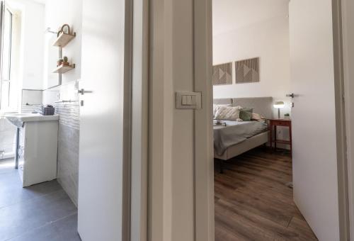 a bedroom with a bed and a room with a door at Casa Terenzio in Rieti