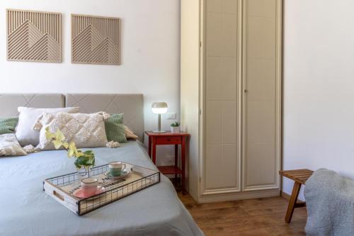 a bedroom with a bed with a tray on it at Casa Terenzio in Rieti