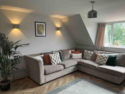 a living room with a couch and a window at Charming 2-Bed Apartment with free parking 10 mins drive to York City in York