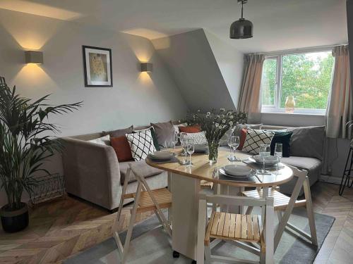 a living room with a table and a couch at Charming 2-Bed Apartment with free parking 10 mins drive to York City in York