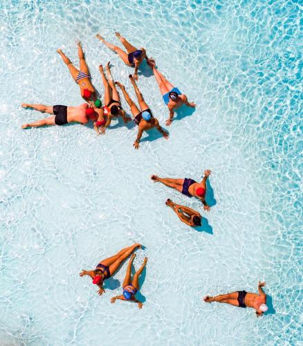a group of people swimming in a swimming pool at Hotel Eldorado in Apiro