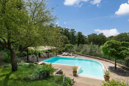 a swimming pool in a yard with trees at Villa Vesta by My Villa Collection in San Casciano dei Bagni